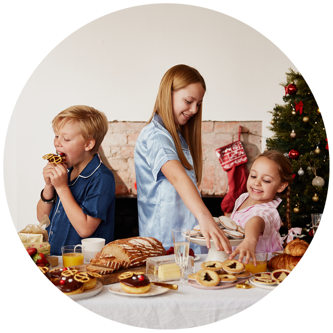 3 children enjoying treats from Banjo's spread out on a Christmas table